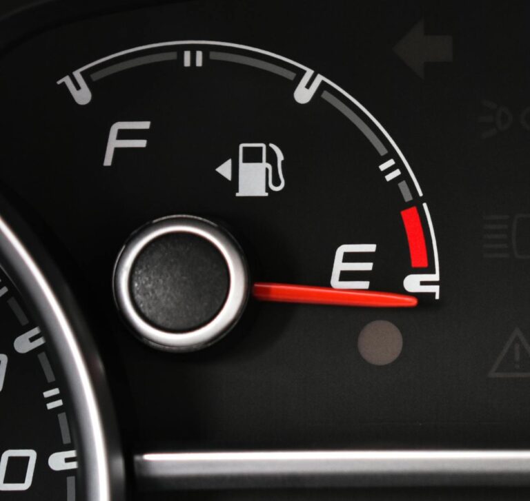 Detailed view of a car's fuel gauge; perseverance means keep going even when you feel like you're on empty